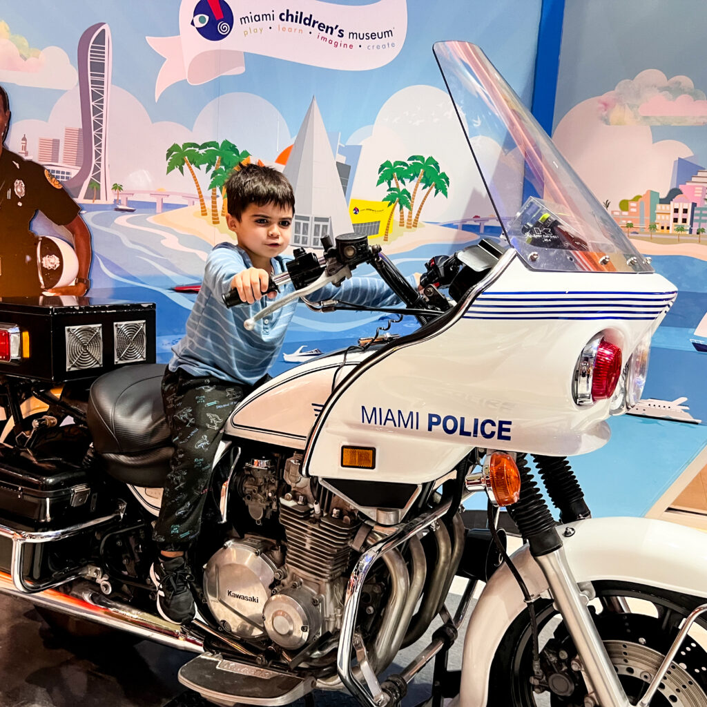 Riding a police motorcycle at Miami Children’s Museum as a Thing to do in Miami with Kids